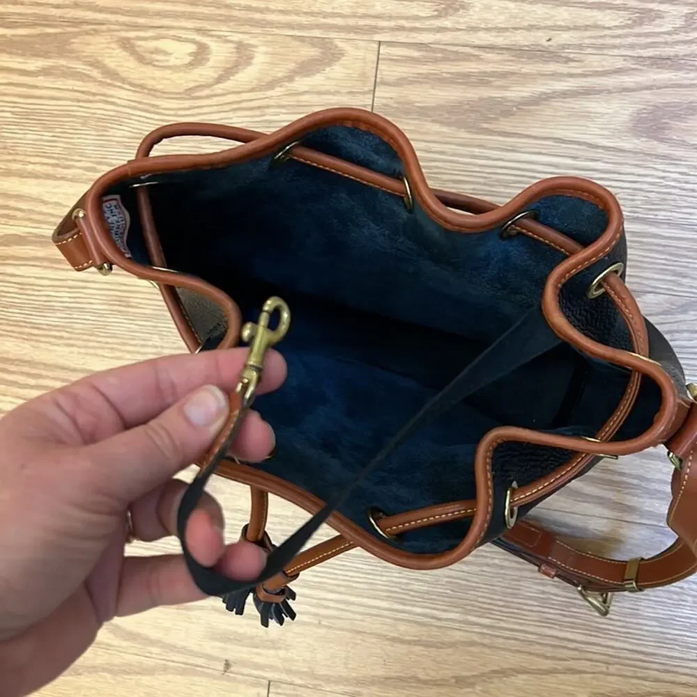 Dooney & Bourke tassel bucket bag blue pebbled leather tan accent gold hardware
